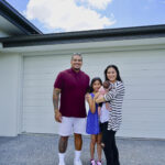 young-family-outside-new-house